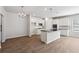 Modern kitchen featuring white cabinets, stainless steel appliances, and a center island with a black countertop at 257 Orwell Dr, Social Circle, GA 30025