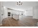 Open-concept kitchen featuring white cabinets, stainless steel appliances, and a large island at 257 Orwell Dr, Social Circle, GA 30025
