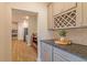 Hallway view of the kitchen with stainless steel appliances and granite counters at 257 Orwell Dr, Social Circle, GA 30025