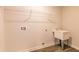 Functional laundry room with sink, hanging rack, and modern plumbing, perfect for efficient home management at 257 Orwell Dr, Social Circle, GA 30025