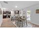 Charming dining area with a farmhouse table and access to the kitchen at 333 Orwell Dr, Social Circle, GA 30025