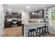 Modern kitchen with dark cabinetry, granite counters, and island at 333 Orwell Dr, Social Circle, GA 30025