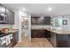 Modern kitchen with dark cabinets, granite counters, and pantry at 333 Orwell Dr, Social Circle, GA 30025