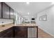Open kitchen features granite countertops and stainless steel dishwasher at 333 Orwell Dr, Social Circle, GA 30025