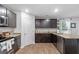 Modern kitchen with dark cabinets, granite counters and pantry at 333 Orwell Dr, Social Circle, GA 30025