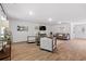 Spacious living room with wood-look floors, neutral decor, and large windows at 333 Orwell Dr, Social Circle, GA 30025