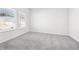Cozy bedroom with plush gray carpet and natural light streaming through the window at 6900 Winchester Pl, Fairburn, GA 30213