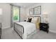 Comfortable bedroom with a wrought iron bed frame, neutral tones, and abundant natural light at 6900 Winchester Pl, Fairburn, GA 30213