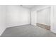 Carpeted bedroom with neutral walls and an open doorway at 6900 Winchester Pl, Fairburn, GA 30213