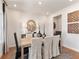 Dining room with modern chandelier, table with seating for six, neutral paint, and hardwood flooring at 6900 Winchester Pl, Fairburn, GA 30213