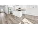 Bright, modern kitchen with stainless steel appliances, a center island, and light wood floors at 6900 Winchester Pl, Fairburn, GA 30213