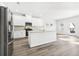 Modern kitchen with white cabinets, stainless steel appliances, and a functional center island at 6900 Winchester Pl, Fairburn, GA 30213