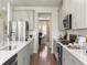 Kitchen showcasing stainless steel appliances, modern white cabinets, and eat-in dining area at 6900 Winchester Pl, Fairburn, GA 30213