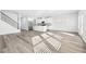 Open-concept living room with hardwood floors flowing into a bright, modern kitchen at 6900 Winchester Pl, Fairburn, GA 30213