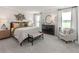 Main bedroom featuring neutral colors, large windows, and plush carpeting at 6900 Winchester Pl, Fairburn, GA 30213