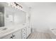 Bathroom with double sink vanity, granite countertops, and tile floors, complemented by a soaking tub and glass shower at 3041 Lexington Ave, Woodstock, GA 30189