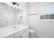 Bathroom featuring white vanity, toilet, and a framed mirror at 3041 Lexington Ave, Woodstock, GA 30189