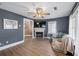 Living room with fireplace, green couch, and hardwood floors at 405 Tanner Rd, Dacula, GA 30019