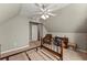 Upstairs bedroom with slanted ceiling, neutral walls, carpeted floors and ceiling fan at 2352 Kelman Pl, Dacula, GA 30019