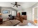 Neutral toned primary bedroom with ceiling fan, carpet floors, and a comfortable seating area at 2352 Kelman Pl, Dacula, GA 30019