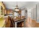 Bright eat-in kitchen featuring an island, stainless appliances, wooden cabinets, and hardwood floors at 2352 Kelman Pl, Dacula, GA 30019