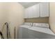 Bright and functional laundry room includes a washer, dryer, and built-in cabinets at 2352 Kelman Pl, Dacula, GA 30019