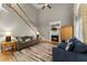 Spacious living room featuring a fireplace, lots of seating and natural light, and hardwood floors at 2352 Kelman Pl, Dacula, GA 30019