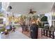 Covered patio featuring a ceiling fan, comfortable seating, and a grill, perfect for outdoor entertaining at 2352 Kelman Pl, Dacula, GA 30019