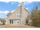 Back exterior featuring light siding, patio area, and lush green landscaping at 2818 Colleton Dr, Marietta, GA 30066