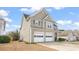 A side view of the home showing the two car garage and light colored siding at 2818 Colleton Dr, Marietta, GA 30066