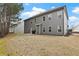 Expansive backyard with a view of the home's exterior, a grill, and a generous lawn at 6120 Sparrow Ln, Cumming, GA 30028