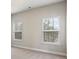 Bedroom features neutral walls and carpet with two windows providing natural light at 6120 Sparrow Ln, Cumming, GA 30028