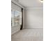 Bright bedroom with a large window and plush neutral carpeting at 6120 Sparrow Ln, Cumming, GA 30028