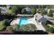 Aerial view of the community pool, featuring a bath house and ample seating for residents and guests at 6120 Sparrow Ln, Cumming, GA 30028