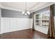 Dining room featuring wainscoting, a chandelier, and hardwood floors at 6120 Sparrow Ln, Cumming, GA 30028