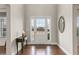 Bright entryway featuring hardwood floors, a glass-paneled front door, and elegant decor, creating a welcoming first impression at 6120 Sparrow Ln, Cumming, GA 30028