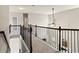 Upper hallway with iron spindles overlooks the main level at 6120 Sparrow Ln, Cumming, GA 30028