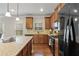 Open kitchen featuring granite countertops, stainless appliances, and a central island at 6120 Sparrow Ln, Cumming, GA 30028