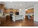 Well-appointed kitchen featuring a central island, desk area, and rich wood cabinetry at 6120 Sparrow Ln, Cumming, GA 30028