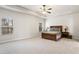 Spacious main bedroom featuring a ceiling fan and large windows at 6120 Sparrow Ln, Cumming, GA 30028