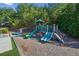 Community playground with slides and climbing features, plus a bench for parents or guardians at 6120 Sparrow Ln, Cumming, GA 30028