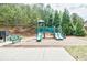 Community playground with slides and climbing features, plus a bench for parents or guardians at 6120 Sparrow Ln, Cumming, GA 30028