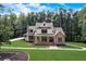 Two-story home with stone and white siding, porch, and landscaping at 5341 Hill Nw Rd, Acworth, GA 30101