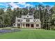 Stunning farmhouse exterior with stone accents and a manicured lawn at 5341 Hill Nw Rd, Acworth, GA 30101