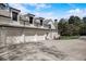 Three-car garage with white doors and gray concrete driveway at 5341 Hill Nw Rd, Acworth, GA 30101