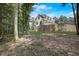 Rear view of house showcasing brick retaining wall and wooded lot at 5341 Hill Nw Rd, Acworth, GA 30101