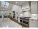 Bright kitchen featuring white cabinets, a large range, and marble countertops at 5341 Hill Nw Rd, Acworth, GA 30101
