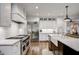 Modern kitchen with white cabinets, stainless steel appliances, and a farmhouse sink at 5341 Hill Nw Rd, Acworth, GA 30101