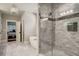 Bathroom with a large walk-in shower and marble tile at 5341 Hill Nw Rd, Acworth, GA 30101