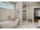 Spa-like bathroom with soaking tub, walk-in shower, and marble flooring at 5341 Hill Nw Rd, Acworth, GA 30101